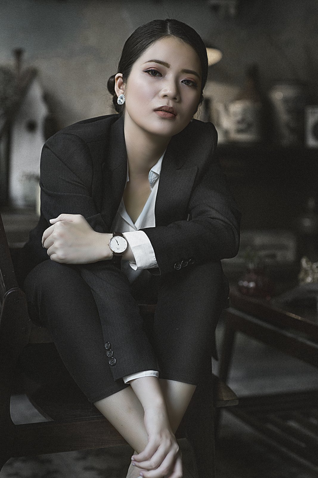 Woman in a structured dark blazer and white shirt, styled for fall 2026 office wear